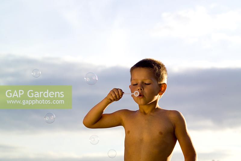 Jeune garçon soufflant des bulles