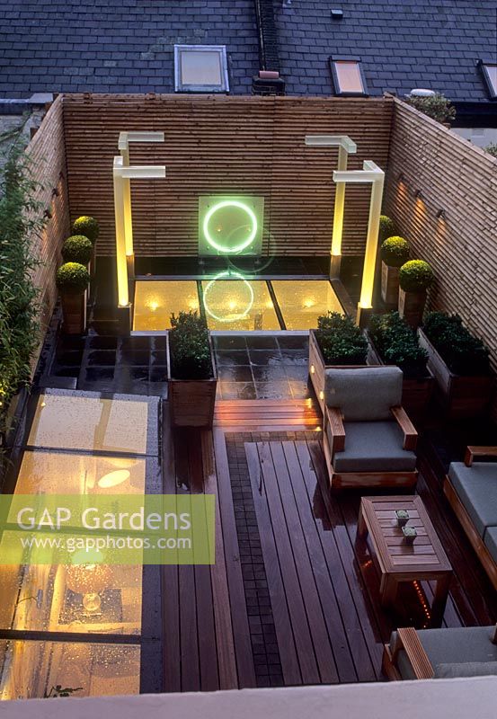 Jardin sur le toit contemporain avec canapé en bois, éclairage et sphères Buxus en pots - Wilton Place Londres