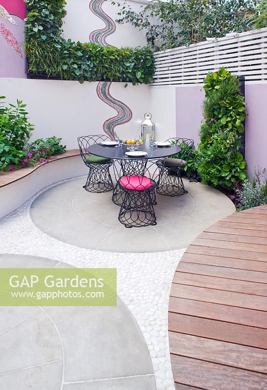 Petit jardin patio avec coin repas et mosaïque par Celia Gregory, Londres.
