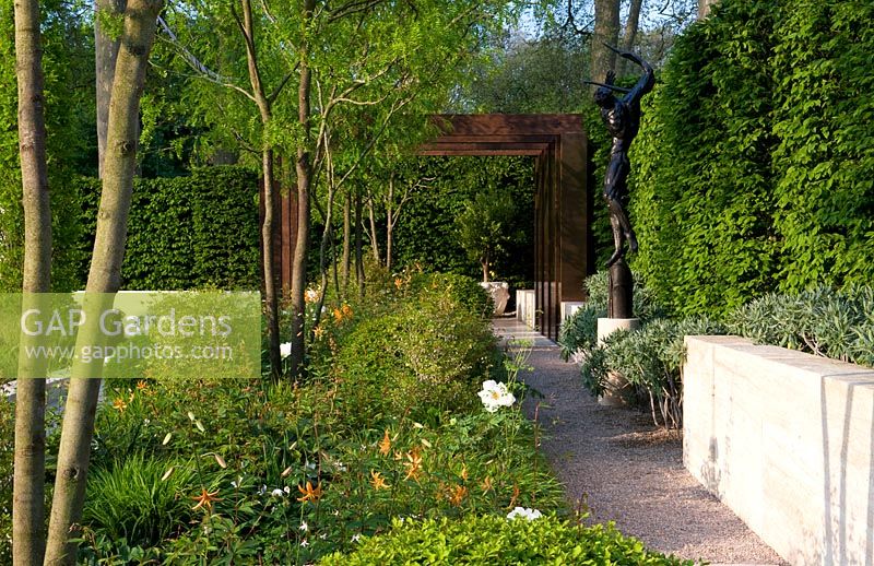 Jardin Laurent Perrier - Gleditsia, verrière surélevée avec plantation ombragée en dessous, y compris enkianthus le long d'un chemin de brique et de gravier droit