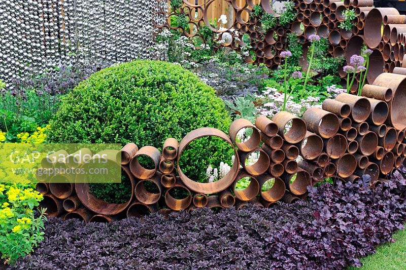 Le jardin SeeAbility, structure de tubes métalliques rouillés le long de parterres de fleurs