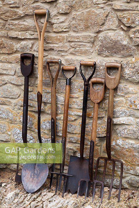 Collection d'outils de jardinage antiques: de gauche à droite, bêche d'argile, bêche de levage de gazon, fourchette à pommes de terre irlandaise, fourchette à carottes, bêche brise-argile, fourches de jardin