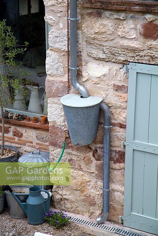 Butée d'eau en acier galvanisé pour recueillir l'eau de pluie du toit. À Grange Rousseau, Tarn, France.