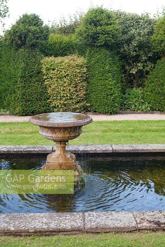 Étang et fontaine en pierre vieillie. Jardin: Rustling End Cottage, Hertfordshire. Propriétaires: M. et Mme Wise