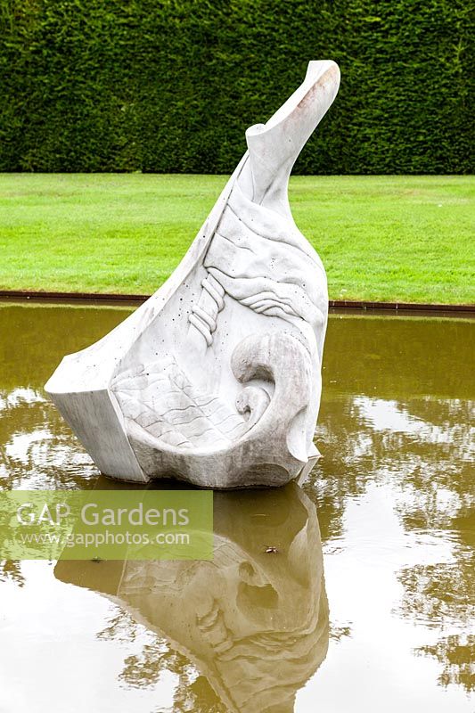 The Pond Garden: Piscine formelle entourée d'une haie de Taxus Baccata. Sculpture de marbre blanc appelé 'Hokusai's Boat' par Jessica Walters, Farleigh House, Farleigh Wallop, Hampshire. Juin. Designer Georgina Langton.