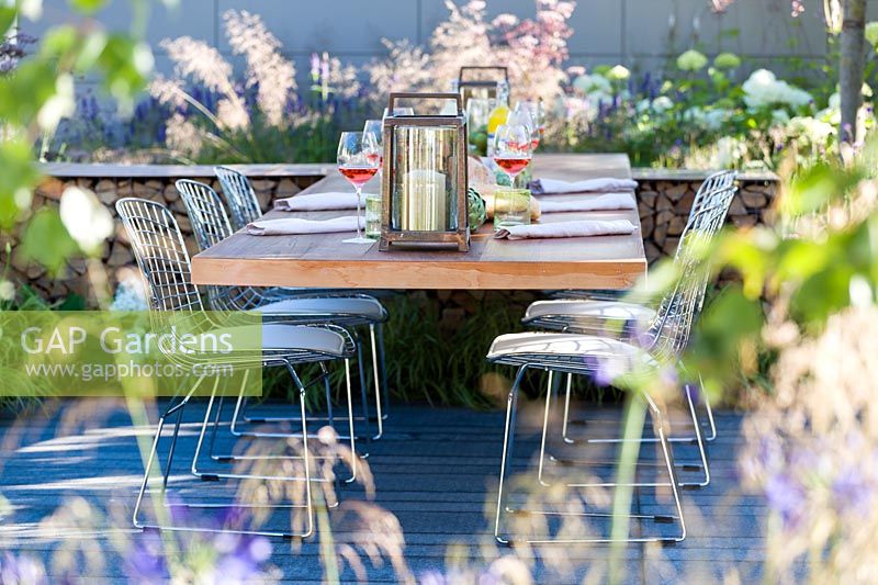 Hampton Court Flower Show 2014, le Vestra Wealth Garden, des. Paul Martin. Table et chaises modernes pour un déjeuner léger en plein air