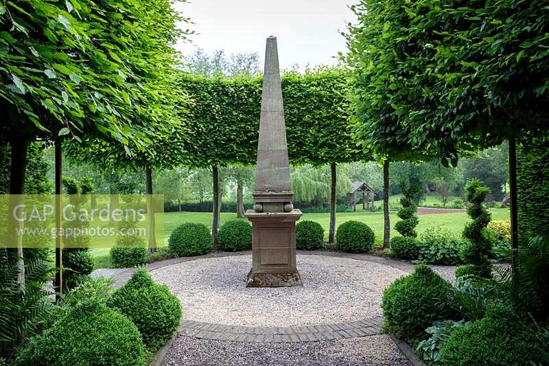 Mitton Manor, Staffordshire. Point focal de l'obélisque de pierre dans le jardin à la française