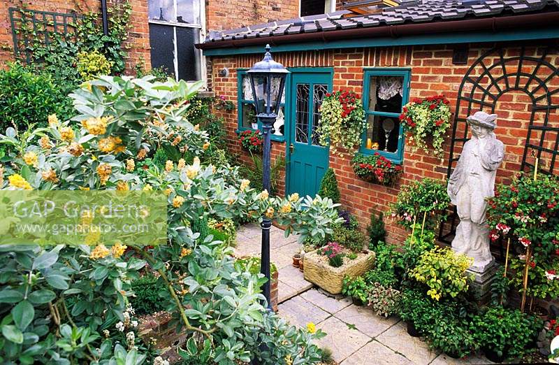 petit jardin privé patio Londres jardin fantastique excentrique avec statue trompe l oeil et Ciste