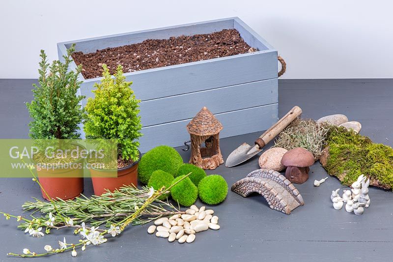 Ingrédients et outils pour planter une boîte de Pâques décorative.