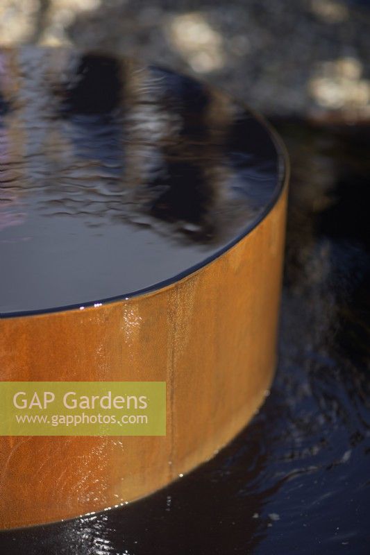 Le jardin de l'empreinte de la mode. Créateur : Baz Grainger. Une pièce d'eau en acier corten. RHS Hampton Court Palace Garden Festival Show 2021