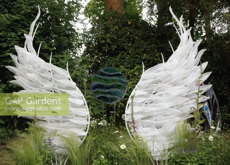 Vue des sculptures en verre 'Solace' de Layne Rowe, composées de 100 plumes de verre individuelles et d'une pièce de jardin circulaire de Galiani Glass Art, organisée par The Glass Garden au Chelsea Flower Show