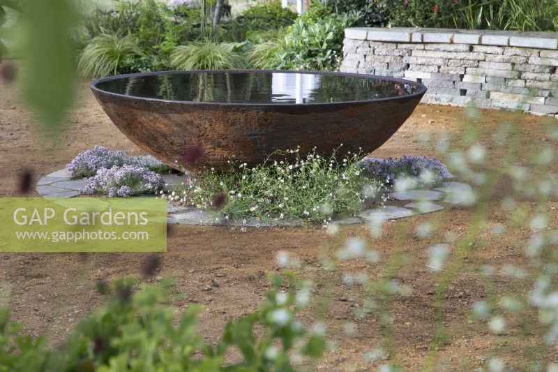Dispositif d'eau circulaire en acier corten dans le RHS Planet-Friendly Garden au RHS Hampton Court Palace Garden Festival 2022