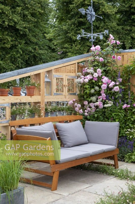 Banc de jardin avec mur de rangement avec rigole d'eau et rosiers grimpants - Knolling avec marguerites, RHS Hampton Court Palace Garden Festival 2022