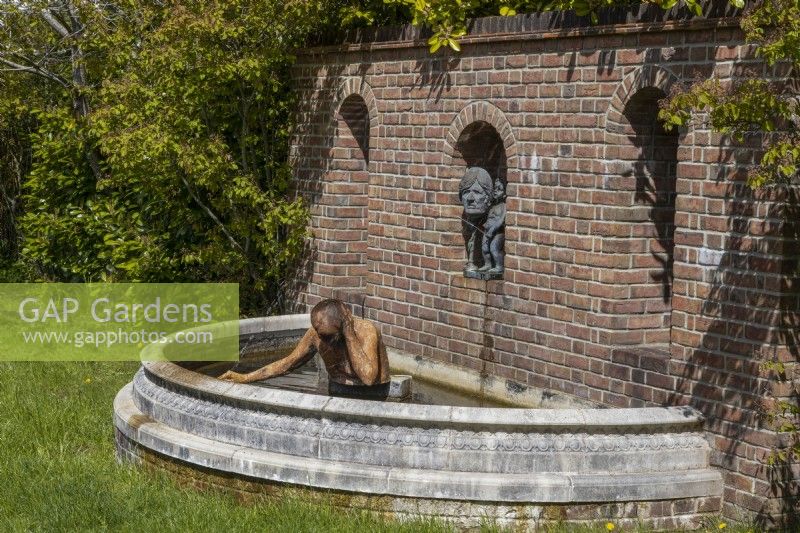 Une statue humoristique et une pièce d'eau. Trago Mills montrent les jardins, Devon, Royaume-Uni. Peut. Printemps