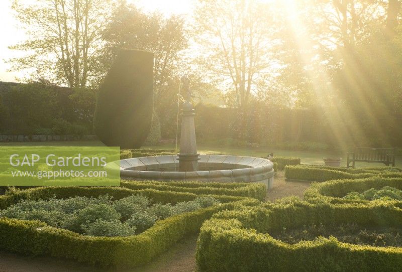 Le jardin de la fontaine au lever du soleil dans le jardin clos du château de Crathes.