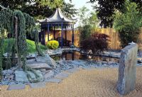 Jardin de style japonais montrant piscine bordée d'ardoise et de pagode en été à l'arrière-plan au Hampton Court Flower Show