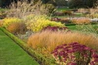 Donnant sur le jardin italien avec des herbes et des têtes de semences de plantes vivaces conçues par Tom Stuart-Smith - Trentham Gardens, Staffordshire, octobre
