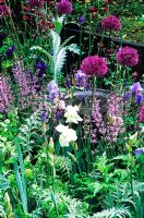 Iris, Allium 'Purple Sensation', Erngium x oliveranum, Centauea montana - Jardin 'A Highland Retreat' - RHS Chelsea Flower Show 2006.