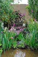 Siège de jardin inhabituel fait de brindilles et de petites branches dans un jardin boisé d'eau semi-sauvage 'Urban Oasis', Hampton Court Palace Flower Show 2012