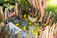 Enfant jouant avec un jardin miniature