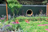 Mur de jardin de bouteilles de vin recyclé, équipé de panneaux solaires. Jardin Greenco Sense. Exposition florale RHS Tatton Park
