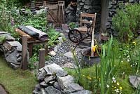 Maladie des motoneurones - un jardin de tisserands hébridiens, basé autour d'une maison noire traditionnelle