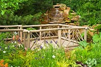 Une cascade de roche de grès et une terrasse en bois en bois de châtaignier - Sentebale - Hope in Vulnerability garden. RHS Chelsea Flower Show 2015.