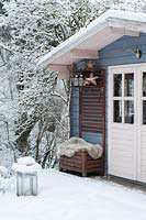 Pavillon bleu en bois recouvert de neige en hiver.