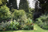 Parterres de fleurs pleines de plantes herbacées vivaces et annuelles, y compris les monardas, les salvias et les nicotianas à Highfield Farm en août.