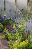 Bordure en terre cuite à côté d'un parterre de fleurs coloré avec Achillea 'Coronation Gold', Allium sphaerocephalon et Perovskia 'Blue Spire' - The Joy Club Garden, RHS Hampton Court Palace Garden Festival 2022